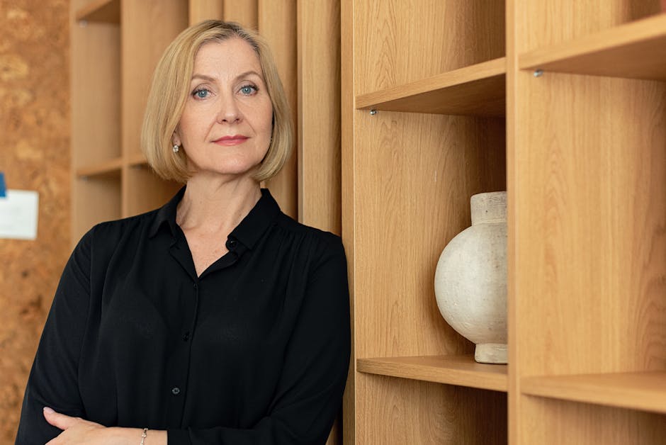 Confident businesswoman standing in an office setting, showcasing leadership.